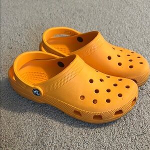 Orange Crocs—Men’s size 7 or Women’s Size 9.
